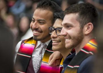 Three graduates smiling at the 密歇根州立大学丹佛 Latinx Graduation Spring 2019